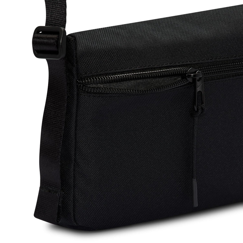 Black crossbody bag with exterior zip pocket and woven shoulder strap