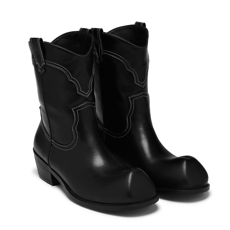 Pair of black leather boots on a white background