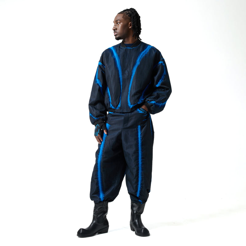 Person wearing a black and blue outfit with a white background