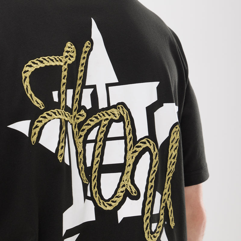 Men's black tee back close-up of large white Houston text with gold rope detailing