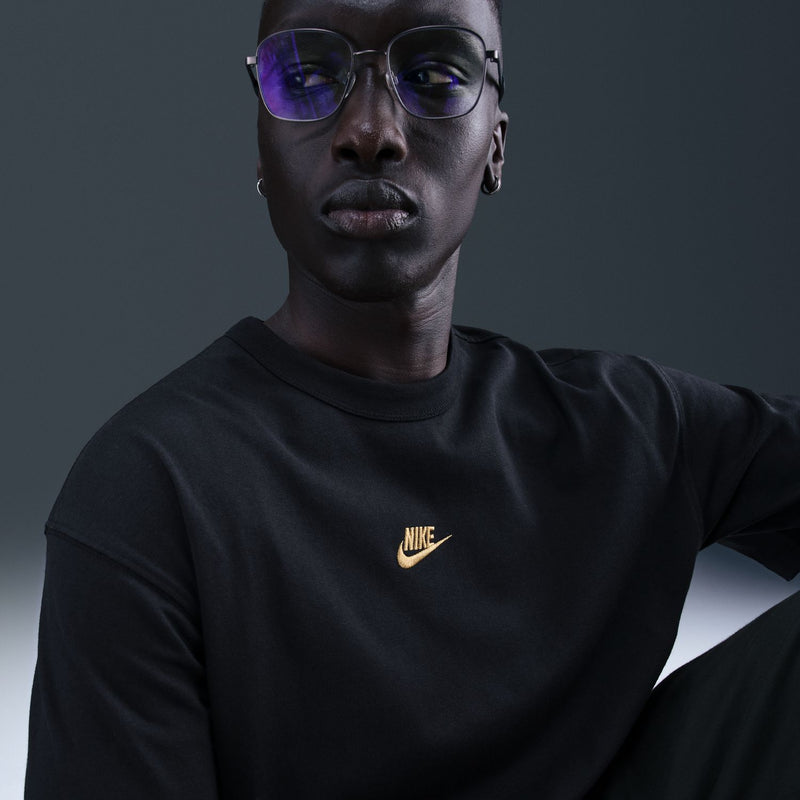 Men's black Nike short-sleeve t-shirt with gold swoosh logo on chest