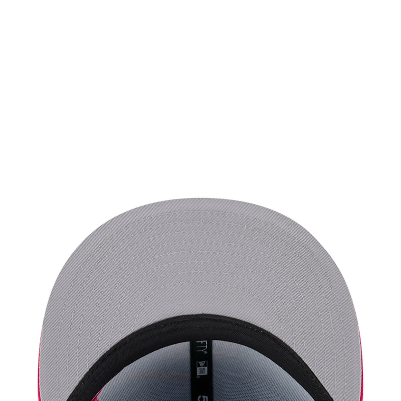 Grey baseball cap with black inner brim, close-up of crown stitching