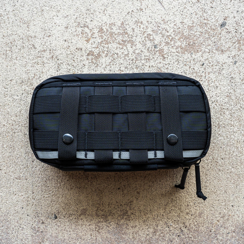 IFAK (Black + Red Thread + Grey Interior + Red Patch) ROBIC w/ Aquaguard, featuring webbing and snap buttons, displayed on a textured beige surface.