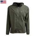 The Indestructible Challenge Windbreaker is an olive green hooded jacket with a front zipper, small logo, and abrasion-resistant ToughDry fabric. Shown on a white background with a US flag in the corner.
