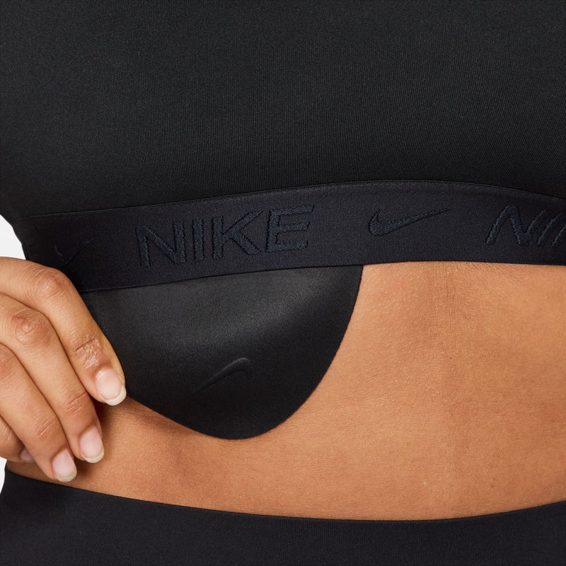 Black sports bra underband detail with Nike branding and hand pulling