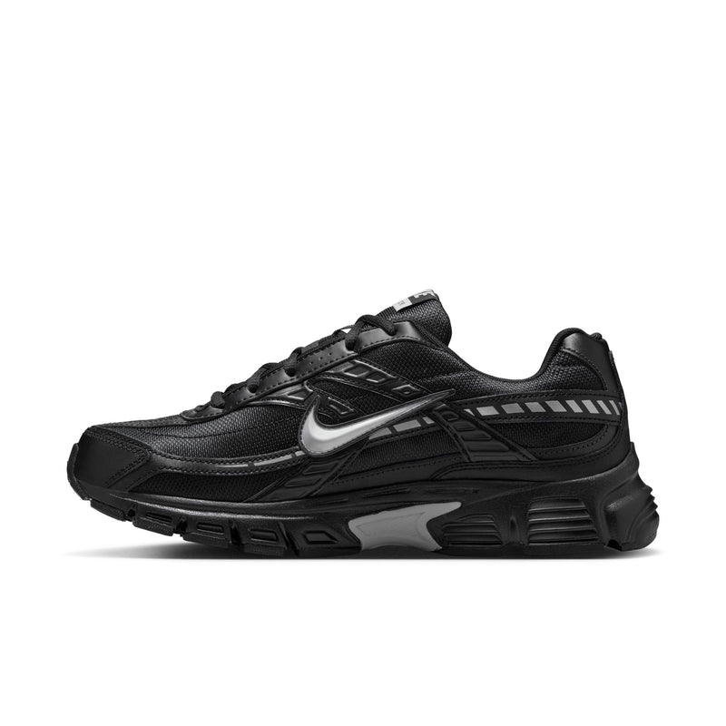 Men's Nike Initiator black sneakers, angled side view with silver Swoosh and straps