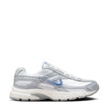 Women’s lace-up running shoe in white with gray panels and blue Nike Swoosh logo.