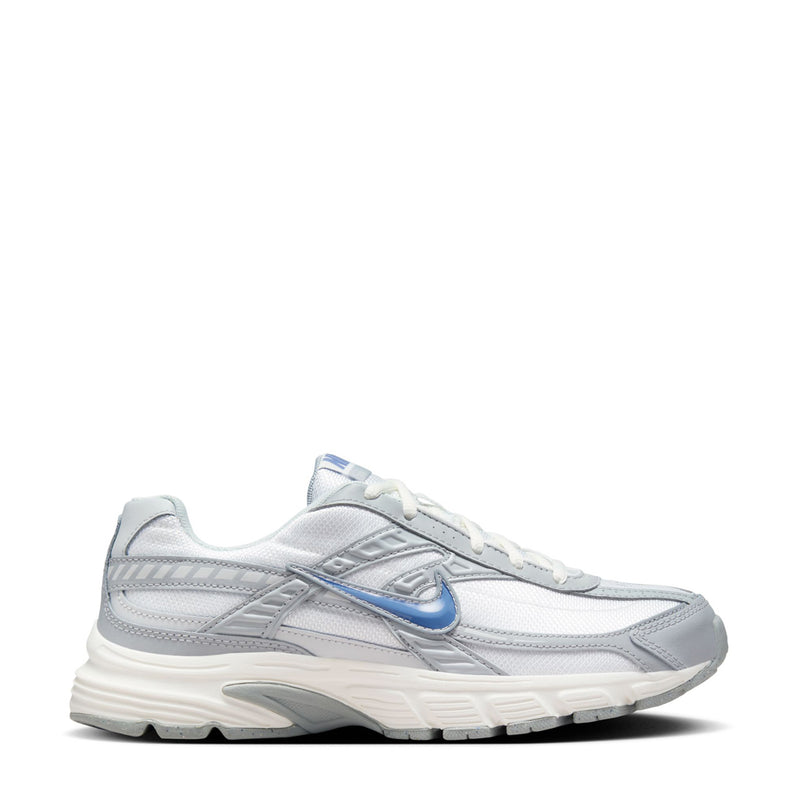 Women’s lace-up running shoe in white with gray panels and blue Nike Swoosh logo.