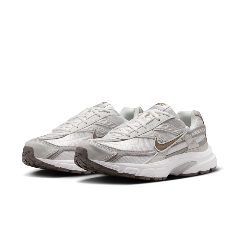 Nike women's running shoes, light bone/gray with layered side panels and laces