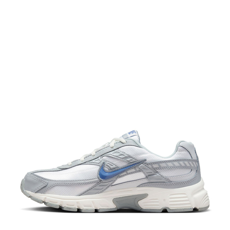 Women’s white and gray lace-up running shoe with blue side Swoosh and cushioned midsole.