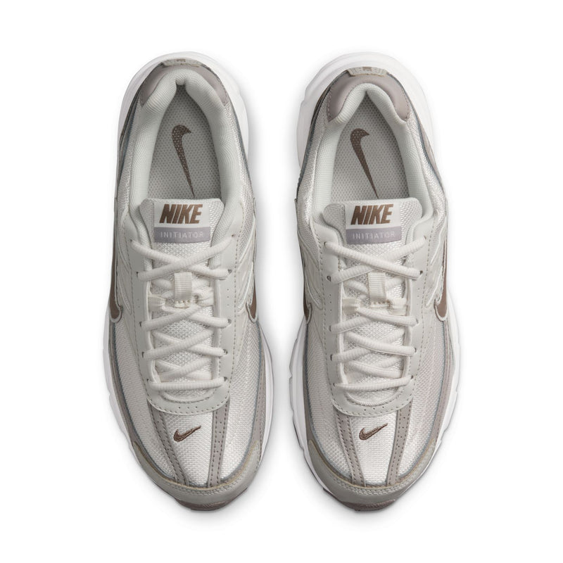 Nike women's running shoes, light bone upper with mesh lining and white lace-up design