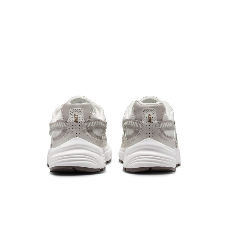 Nike women's running shoes, light bone with cushioned collar and chunky white sole