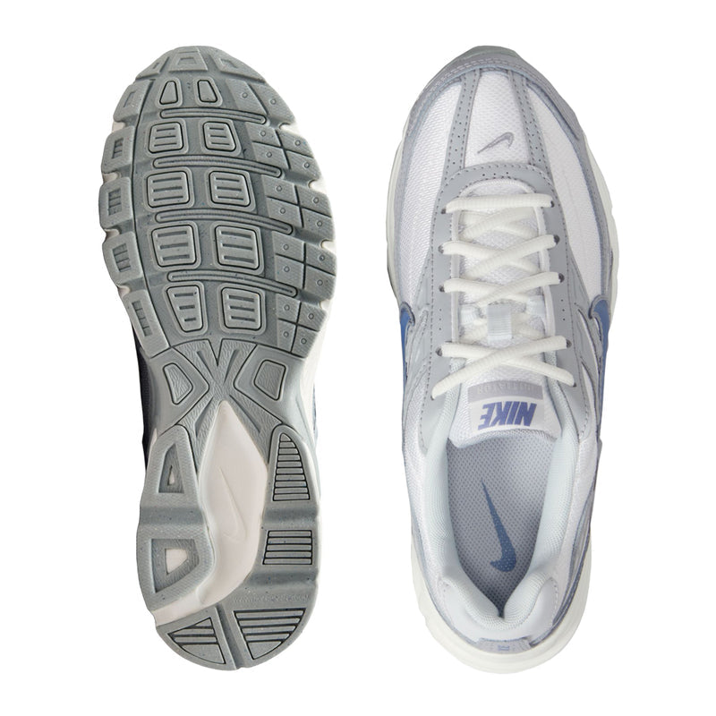 Women’s white lace-up running shoe with blue Swoosh, shown from outsole and inner side.