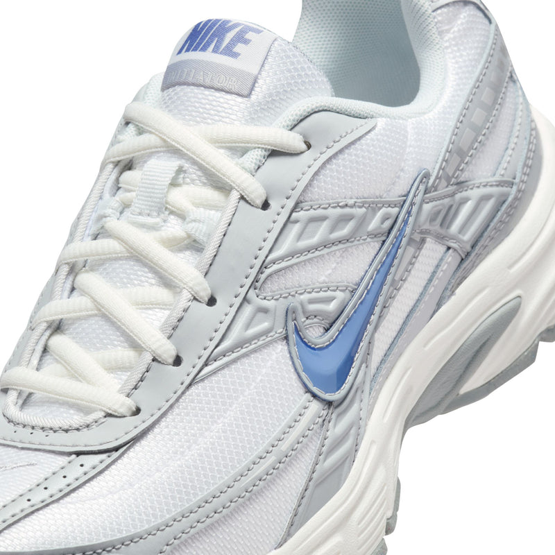 Close-up of women’s white lace-up running shoe with blue Swoosh and stitched overlay details.