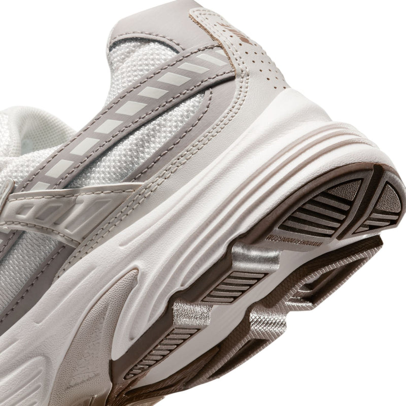 Nike women's running shoes, heel close-up with stitched stripes and textured sole