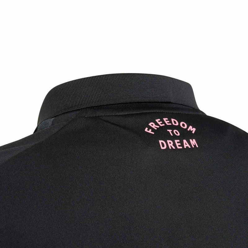 Youth black soccer jersey back collar with pink text: Freedom to Dream