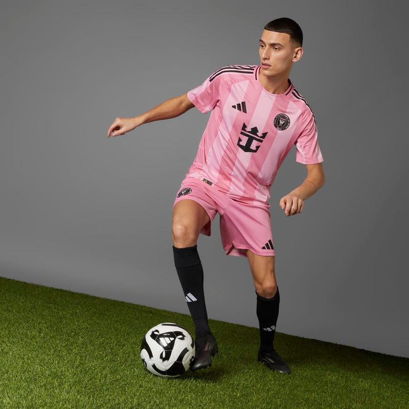 Men's light pink home soccer jersey, running pose with black Adidas shoulder stripes