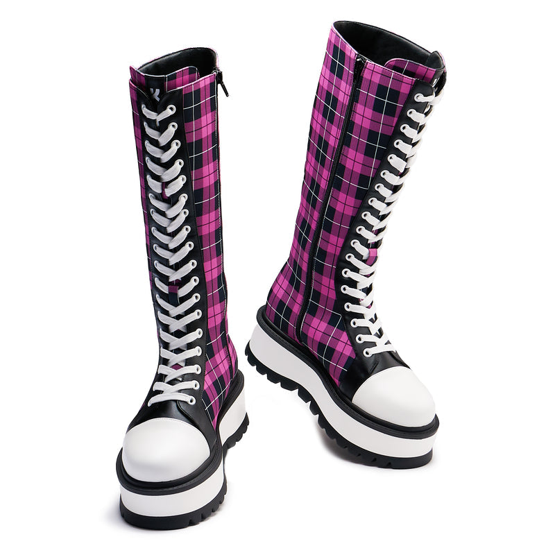 A pair of long platform boots with a pink checkered pattern, featuring a chunky sole and lace-up closure - front view