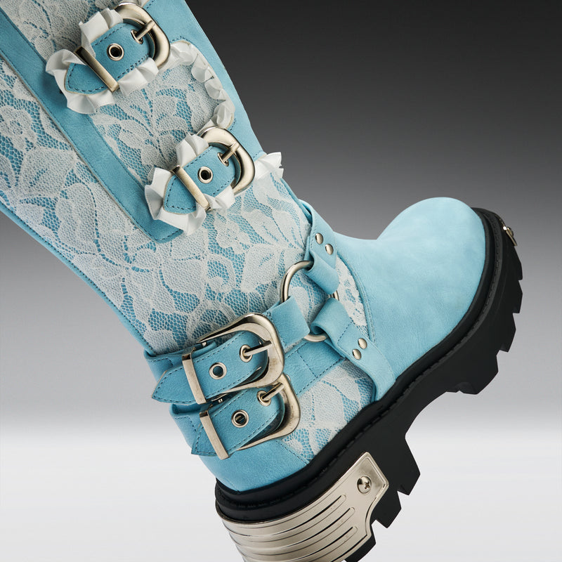 Light blue boot with floral lace design and metal buckles on a gray background