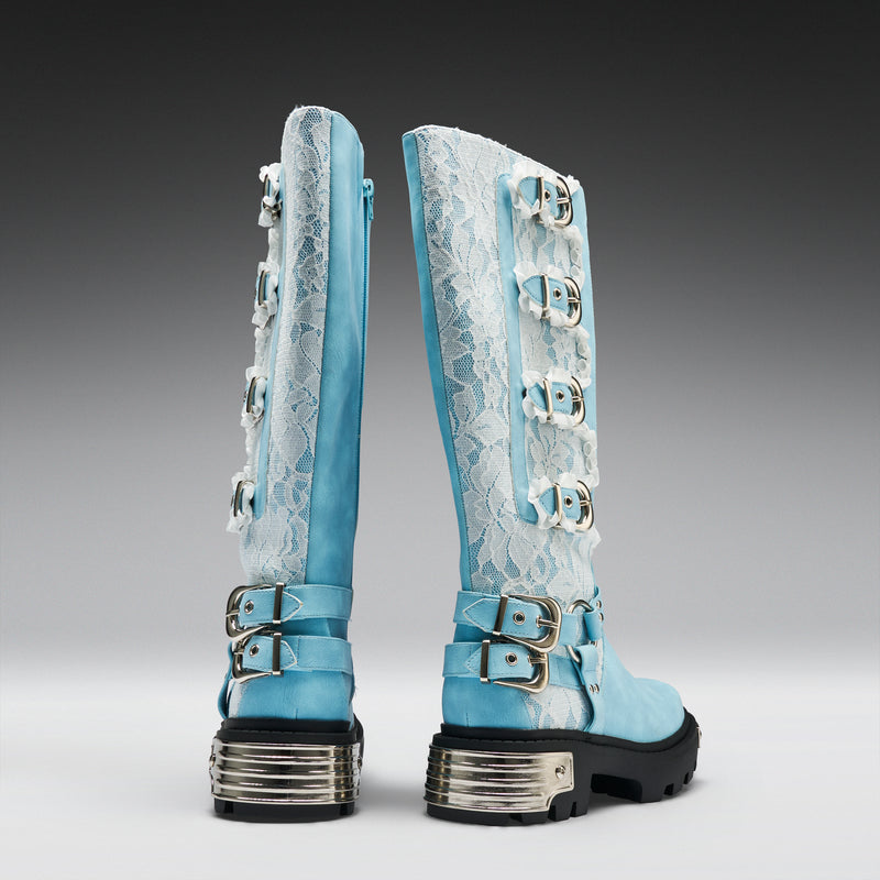 Pair of light blue knee-high boots with silver buckles on a gray background