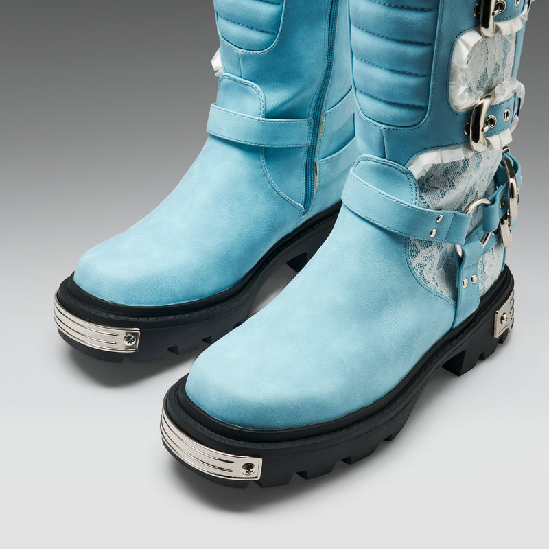 Light blue boots with black soles and silver accents on a gray background