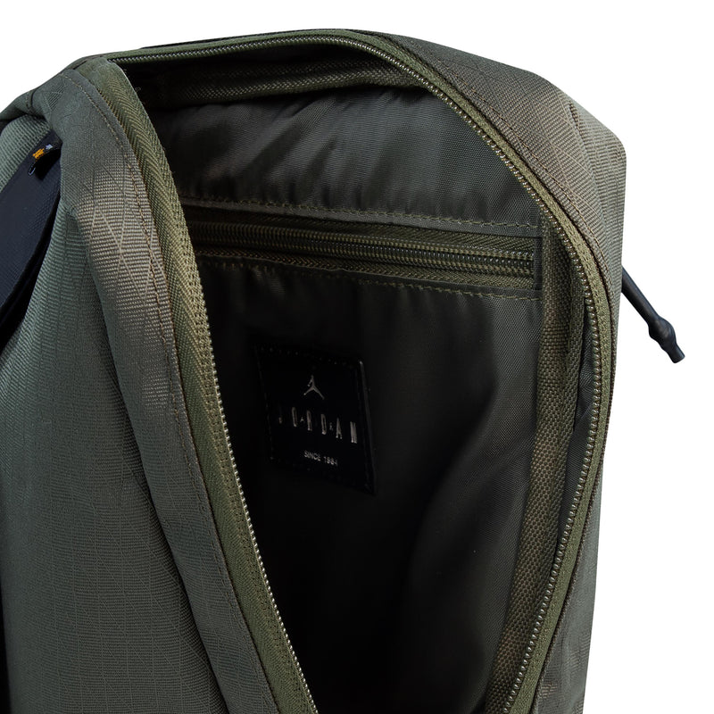 Medium olive crossbody bag interior view with zipper pocket and black lining
