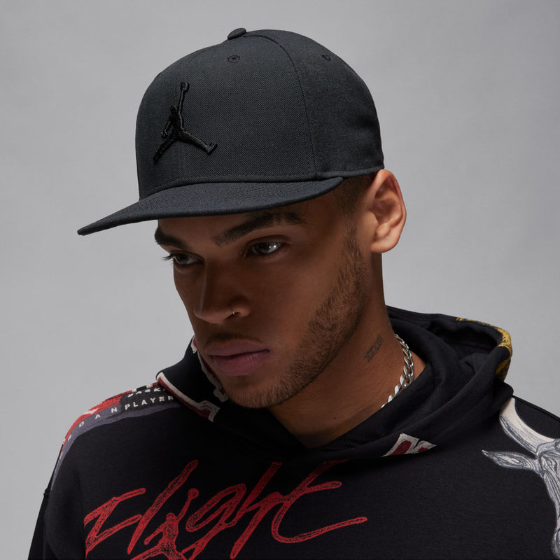 Black snapback cap with Jumpman logo, worn by model.