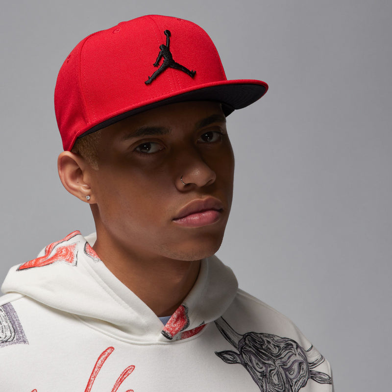 Red snapback cap with black Jumpman logo on front, side profile
