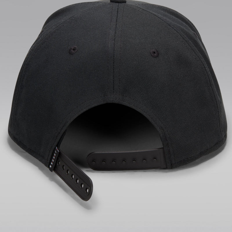 Black snapback cap back with adjustable strap and size holes.