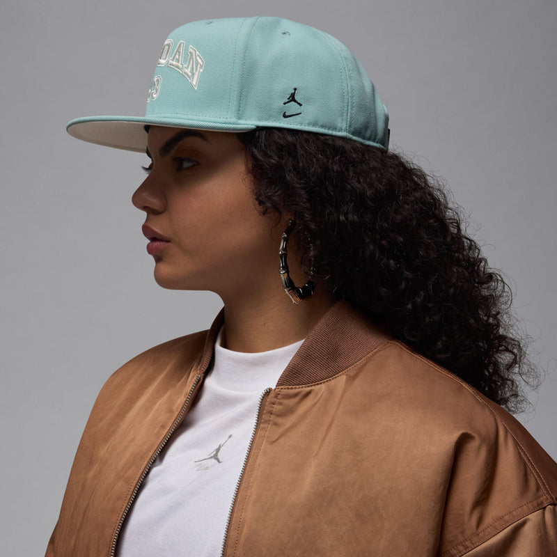Light teal snapback cap with Jumpman logo on front and flat bill, side profile