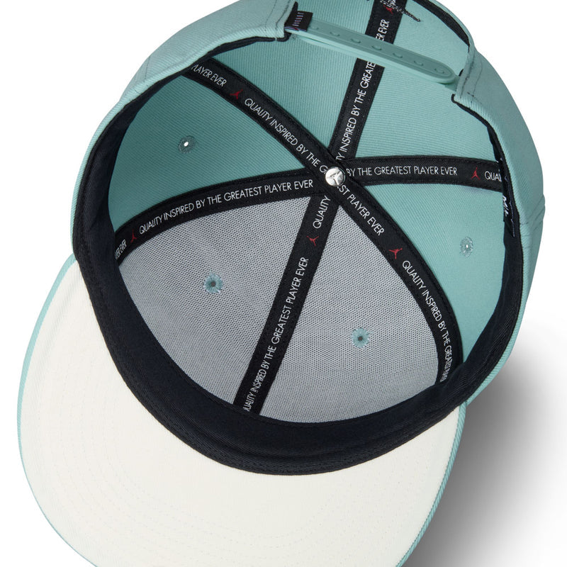 Light teal snapback cap interior with black trim and adjustable strap hardware