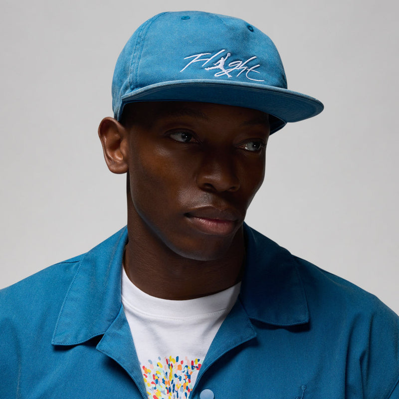 Faded blue strapback cap with curved brim and white “Flight” logo