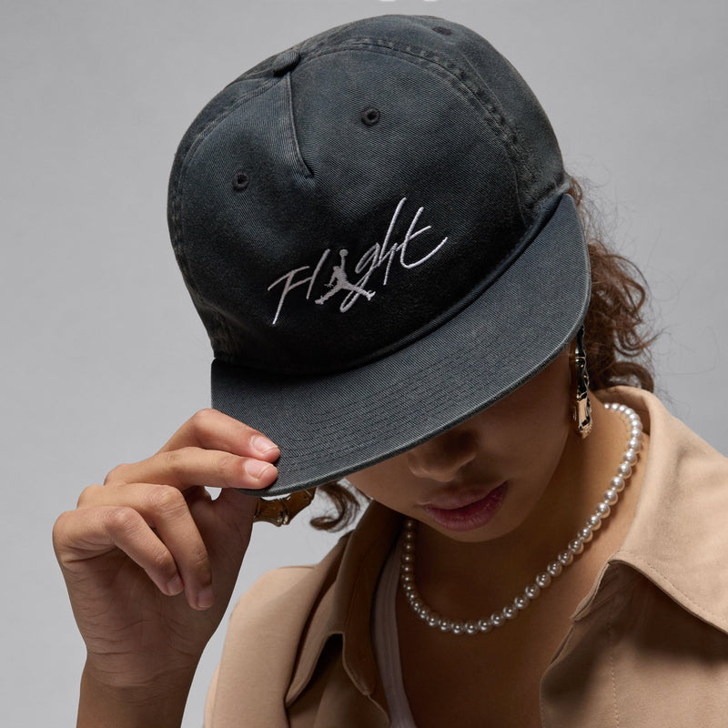 Dark 5-panel strapback cap with white Fitght logo, side view