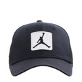 Black trucker cap with white Jumpman patch on the front panel