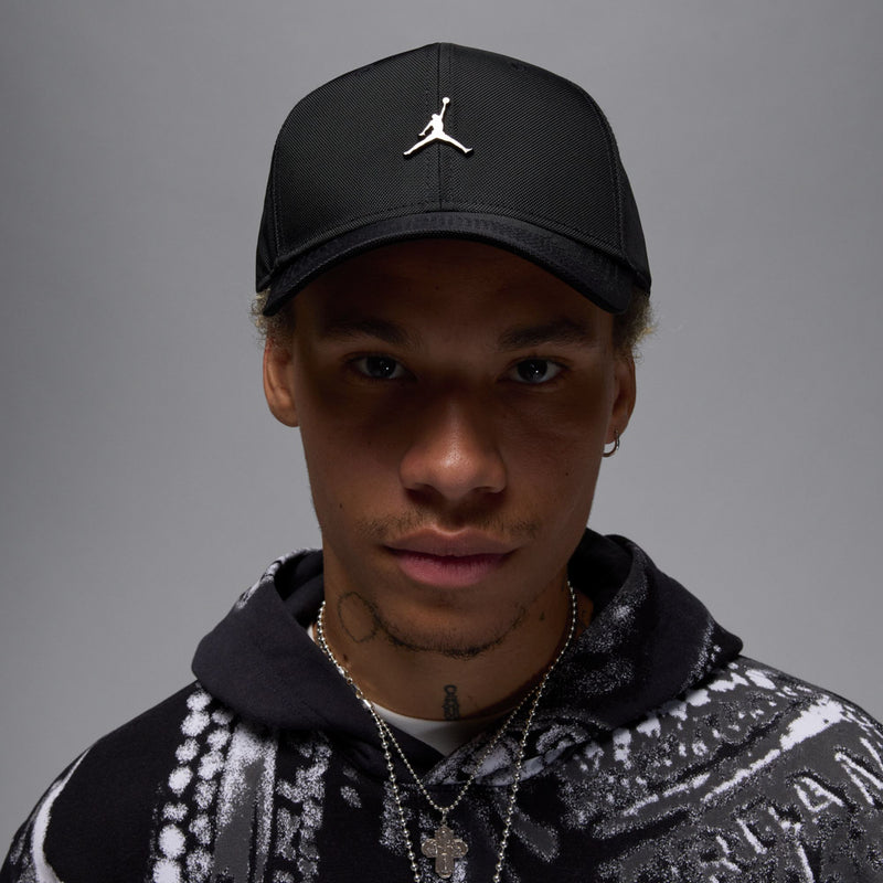 Black cap with metal Jumpman on front and curved bill, strapback closure