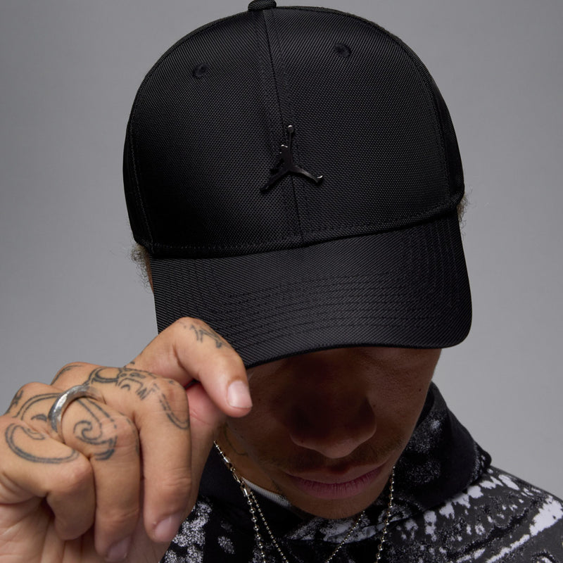 Black textured cap with metal Jumpman logo on front, curved bill