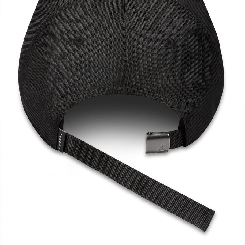 Black cap with adjustable woven strap and metal slider buckle