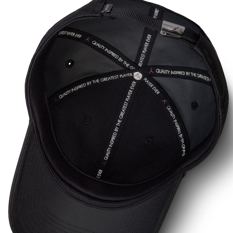 Black cap interior with stitched eyelets and adjustable strap backing