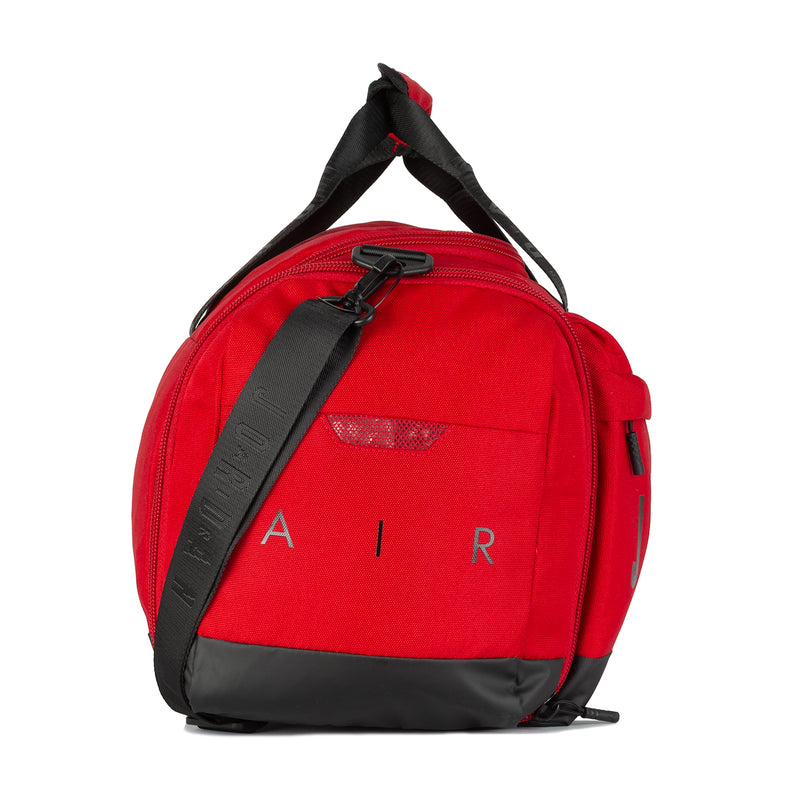 Small red duffel with front zipper, black strap, and AIR letters