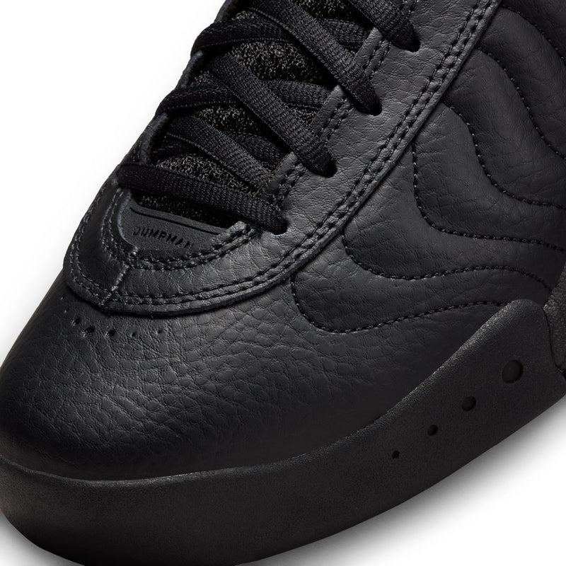 Close-up of black leather sneaker with laces, stitched seams, and Jumpman tongue patch