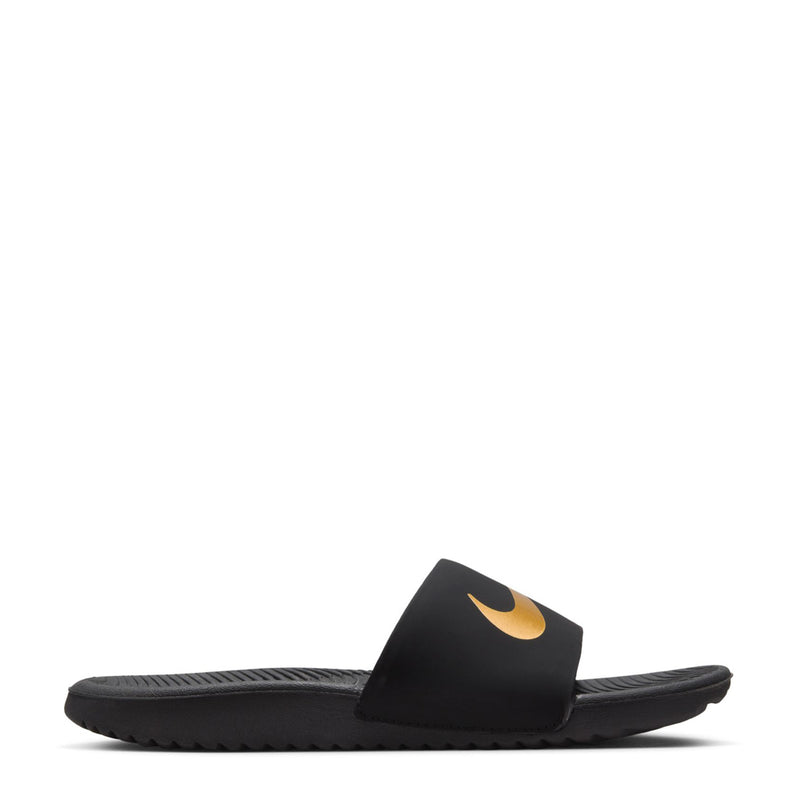 Kids' black slide sandals with gold Nike swoosh on the footbed