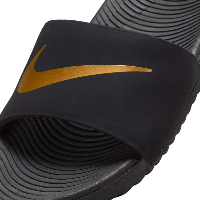 Kids' black slide sandals close-up of gold swoosh on the strap