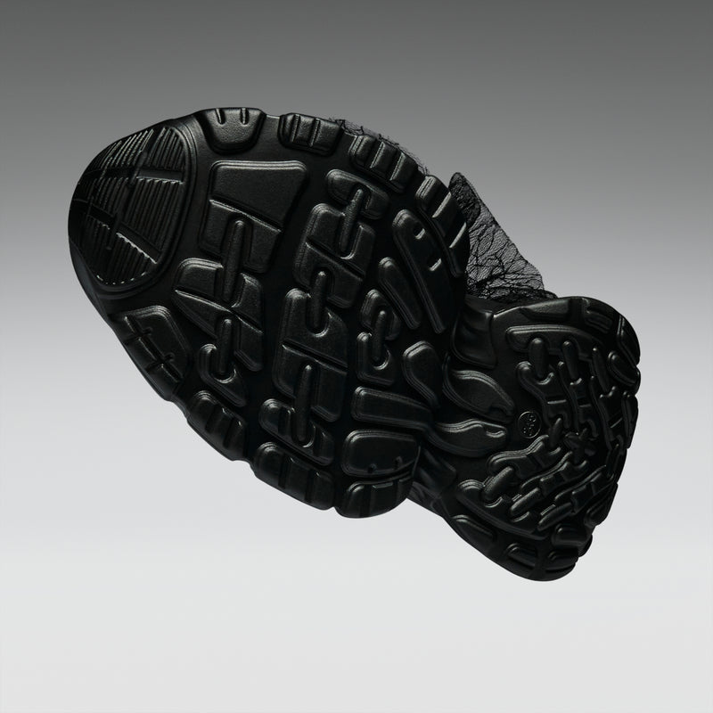 Close-up of a black shoe sole on a gray background