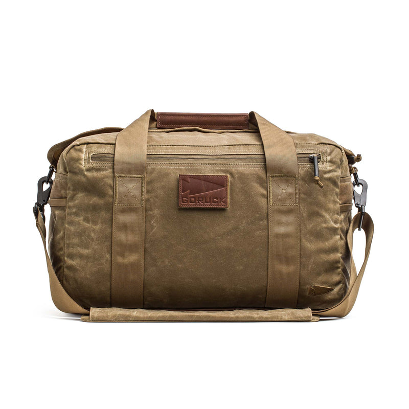 The Kit Bag - Waxed Canvas is a tan duffel inspired by classic aviator kit bags, featuring handles, a shoulder strap, and a leather front patch that reads "GORUCK.