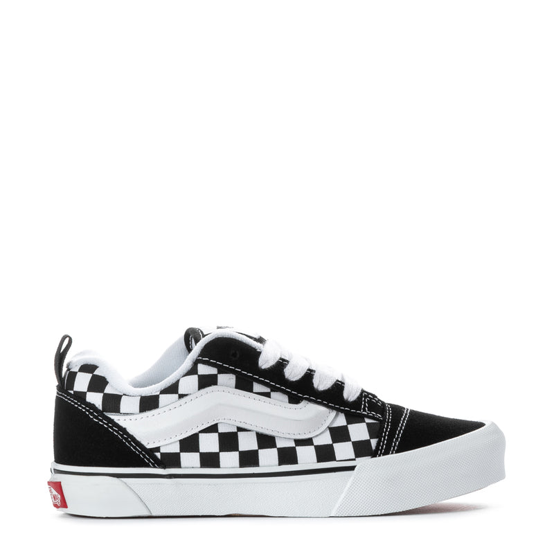 Kids low-top sneaker side view, black canvas with white checkered band, lace-up