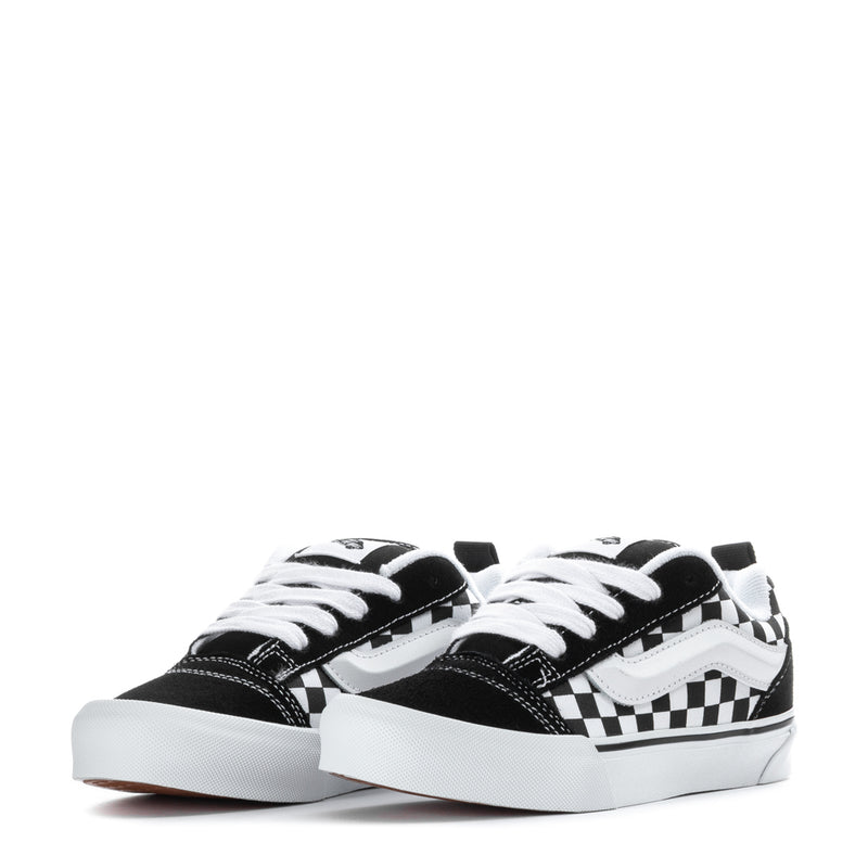 Kids low-top sneakers, black and white checkered panels, white laces, rubber sole
