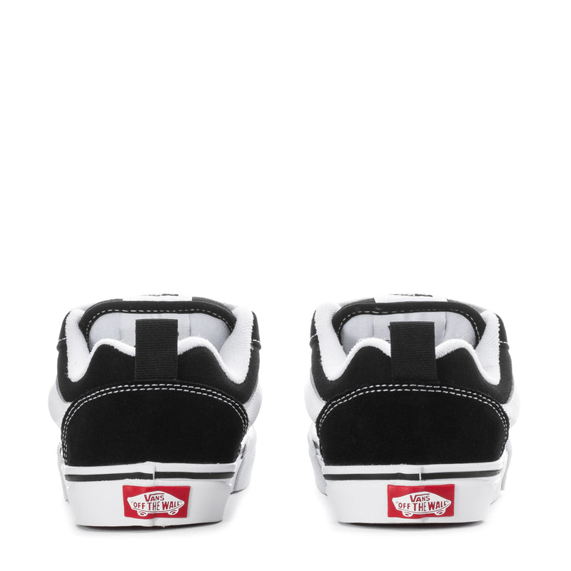 Kids black-and-white low-top skate shoes with Vans 'Off The Wall' heel label.