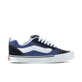 Men's low-top sneakers in navy and white with white laces and rubber sole.