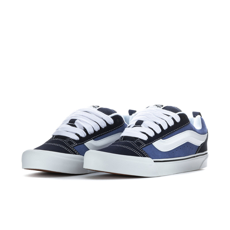 Men's navy and white low-top sneakers, two pairs shown with white laces.