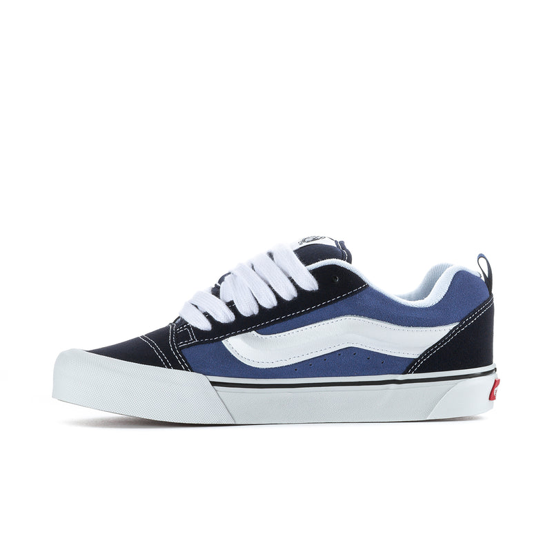 Men's navy and white low-top sneakers, side view with white laces and swoosh panel.